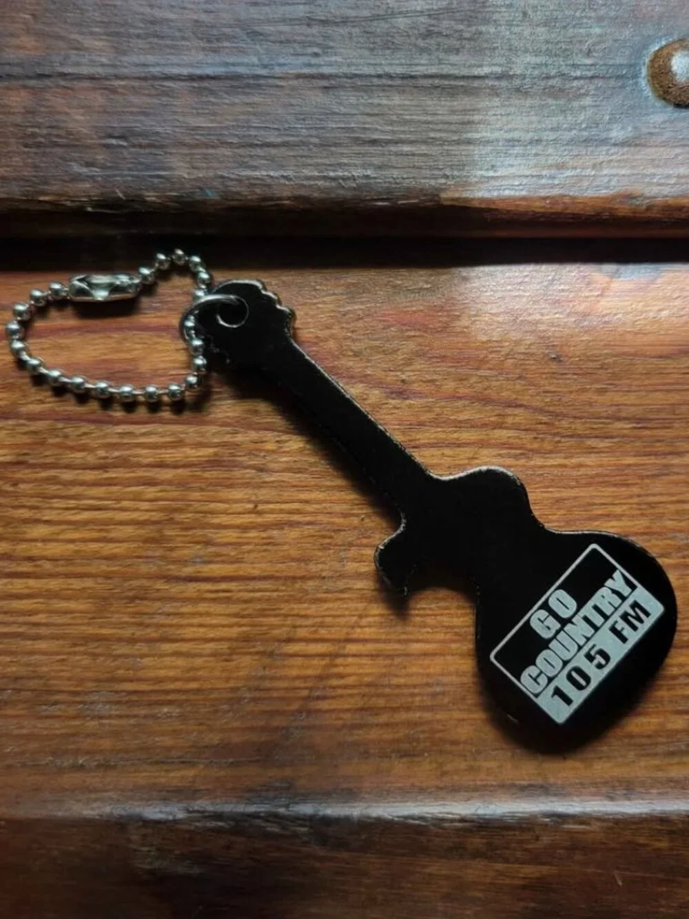 Guitar-Shaped Black Keychain And Promotional Bottle Opener